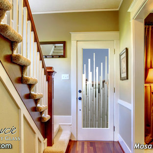 Photo of a mid-sized eclectic front door in Other with beige walls, dark hardwood floors, a single front door and a glass front door.