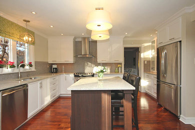 Inspiration for a large transitional l-shaped dark wood floor eat-in kitchen remodel in Ottawa with an undermount sink, shaker cabinets, white cabinets, granite countertops, gray backsplash, glass tile backsplash, stainless steel appliances, an island and white countertops