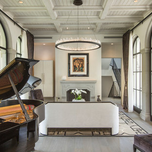 Mediterranean enclosed living room in Orange County with a music area, white walls, light hardwood flooring, a standard fireplace, a stone fireplace surround, grey floors and no tv.