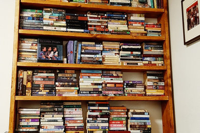 Example of a large mountain style open concept vinyl floor family room library design in Toronto with white walls and a corner tv