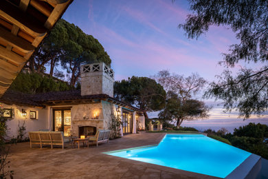 Pool - mid-sized rustic front yard stone and custom-shaped infinity pool idea in Los Angeles