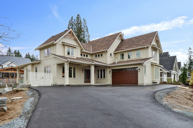 Large transitional beige three-story concrete fiberboard and board and batten house exterior photo in Vancouver with a butterfly roof, a shingle roof and a brown roof