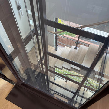 Project #136 | Modern Floating Staircase Encircling Glass Elevator