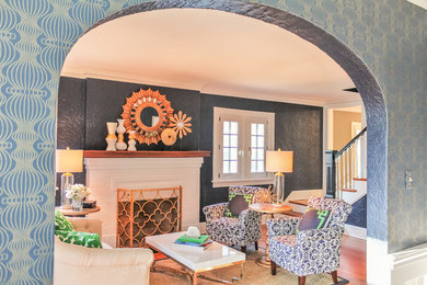 Living room - mid-sized transitional enclosed medium tone wood floor and brown floor living room idea in St Louis with blue walls, a standard fireplace and a wood fireplace surround