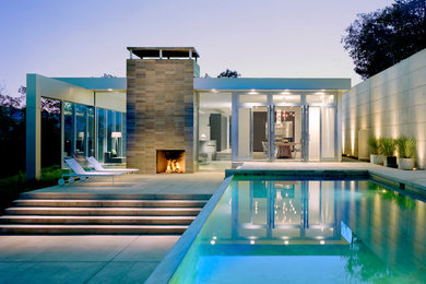 Inspiration for a mid-sized contemporary white one-story glass exterior home remodel in New York with a mixed material roof
