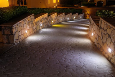 Photo of a mid-sized transitional front yard stone retaining wall landscape in San Diego.