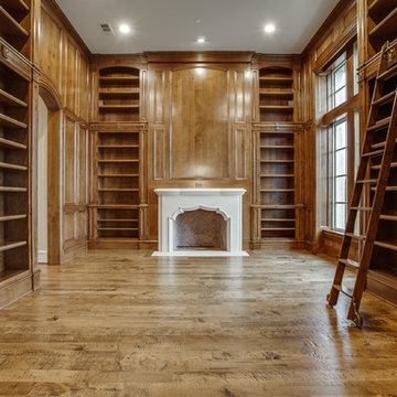 two story home libary with rolling libary ladder