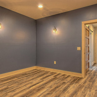 Inspiration for a large craftsman enclosed vinyl floor and brown floor home theater remodel in Atlanta with blue walls and a wall-mounted tv