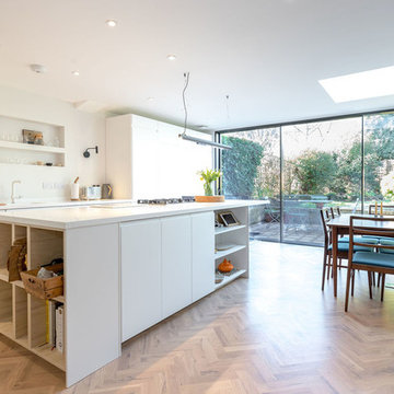 Bright open plan kitchen diner with full width sliding patio doors