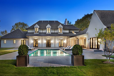 Large white two-story stucco exterior home photo in DC Metro