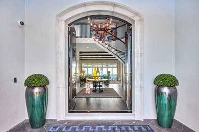 Example of a large transitional dark wood floor and brown floor entryway design in Tampa with gray walls and a dark wood front door