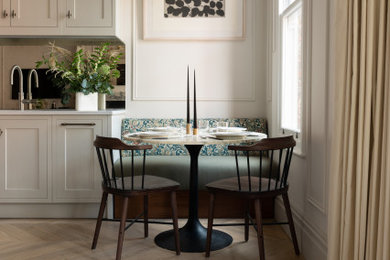 Inspiration for a contemporary dining room in London with medium hardwood flooring and beige floors.