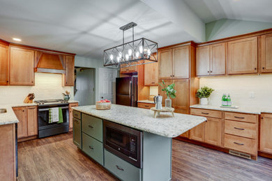 Enclosed kitchen - large traditional u-shaped vinyl floor and brown floor enclosed kitchen idea in Other with an undermount sink, recessed-panel cabinets, medium tone wood cabinets, granite countertops, white backsplash, ceramic backsplash, stainless steel appliances, an island and gray countertops