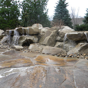 Carved stone water feature pondless and stone patio
