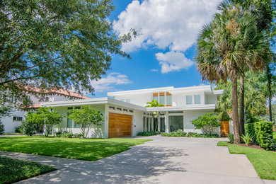 Inspiration for a large contemporary white two-story mixed siding exterior home remodel in Tampa