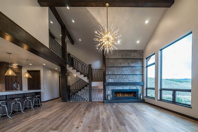 Living room - mid-sized transitional open concept light wood floor living room idea in Denver with beige walls, a standard fireplace, a stone fireplace and no tv