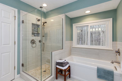 Photo of a mid-sized transitional master bathroom in Other with shaker cabinets, medium wood cabinets, an alcove tub, an alcove shower, a two-piece toilet, gray tile, porcelain tile, green walls, porcelain floors, an undermount sink, granite benchtops, grey floor, a hinged shower door and grey benchtops.