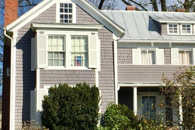 Example of a large classic gray two-story wood exterior home design in DC Metro with a metal roof