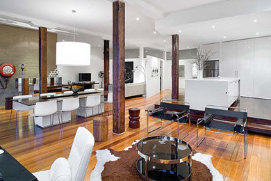 This is an example of a large open concept family room in Melbourne with medium hardwood floors.