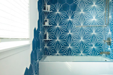 Inspiration for a mid-sized eclectic blue tile and porcelain tile porcelain tile, blue floor and single-sink bathroom remodel in Minneapolis with flat-panel cabinets, medium tone wood cabinets, a two-piece toilet, white walls, a drop-in sink, quartz countertops, a hinged shower door, white countertops and a built-in vanity