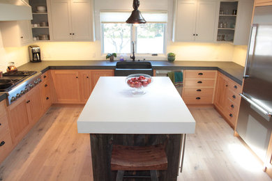 Example of a trendy eat-in kitchen design in San Francisco with flat-panel cabinets, light wood cabinets, white backsplash, ceramic backsplash and stainless steel appliances