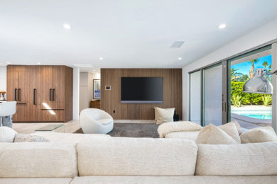 Example of a minimalist ceramic tile, yellow floor and wall paneling living room design in Other with multicolored walls, no fireplace and a wall-mounted tv