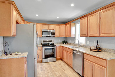 Inspiration for a mid-sized modern ceramic tile and brown floor kitchen remodel in DC Metro with an undermount sink, shaker cabinets, brown cabinets, granite countertops, stainless steel appliances and brown countertops