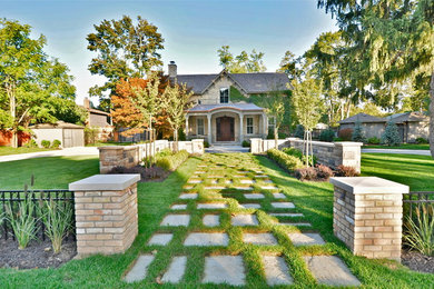 This is an example of a traditional front yard garden in Toronto with natural stone pavers.