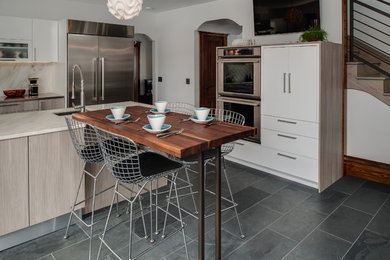 Eat-in kitchen - large modern l-shaped slate floor eat-in kitchen idea in Other with an undermount sink, flat-panel cabinets, light wood cabinets, marble countertops, multicolored backsplash, stone slab backsplash, stainless steel appliances and an island