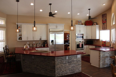 Trendy porcelain tile kitchen photo in Phoenix with an undermount sink, raised-panel cabinets, white cabinets, quartz countertops, stainless steel appliances and no island