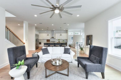 Inspiration for a mid-sized coastal formal and open concept light wood floor and brown floor living room remodel in Jacksonville with white walls, no fireplace and no tv