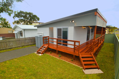 Photo of a traditional one-storey white exterior in Central Coast with a flat roof.