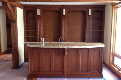 Inspiration for a mid-sized timeless medium tone wood floor wet bar remodel in Other with an undermount sink, medium tone wood cabinets and granite countertops