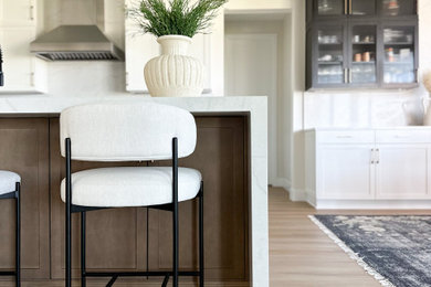 Inspiration for a mid-sized modern u-shaped light wood floor and brown floor open concept kitchen remodel in Denver with an undermount sink, shaker cabinets, white cabinets, white backsplash, stainless steel appliances, an island and white countertops