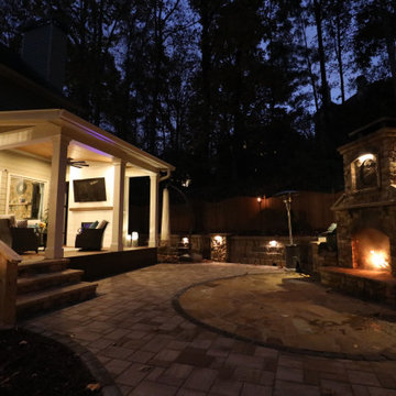 Nighttime Outdoor Living Area with Fireplace & Covered Patio