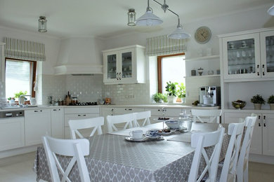 Inspiration for a large timeless u-shaped ceramic tile eat-in kitchen remodel in Other with glass-front cabinets, white cabinets, white backsplash and subway tile backsplash