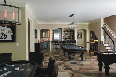 Inspiration for a timeless walk-out basement remodel in Atlanta with beige walls, a standard fireplace and a stone fireplace