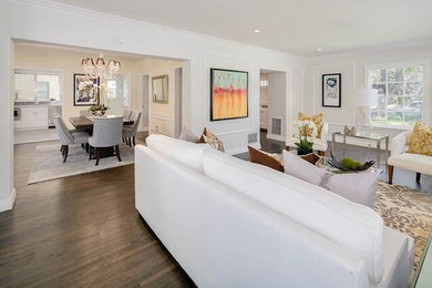 Example of a large transitional open concept dark wood floor and brown floor family room design in Orange County with white walls, a standard fireplace and a stone fireplace