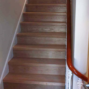 Solid walnut parquet floor in a herringbone pattern with matching staircase