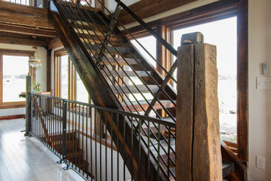 Staircase - rustic wooden straight open and metal railing staircase idea in Other