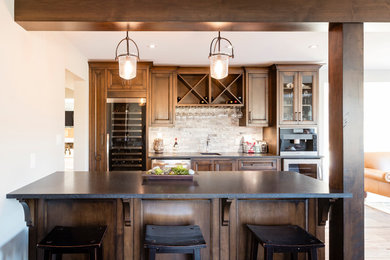 This is an example of a mid-sized country kitchen/dining combo in Toronto with white walls, medium hardwood floors, no fireplace and brown floor.