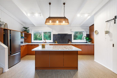 Large contemporary eat-in kitchen in Melbourne with a farmhouse sink, flat-panel cabinets, orange cabinets, tile benchtops, blue splashback, cement tile splashback, stainless steel appliances, cork floors, with island, beige floor, multi-coloured benchtop and wood.