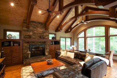 This is an example of a large country formal open concept living room in Other with beige walls, medium hardwood floors, a standard fireplace, a stone fireplace surround, no tv and beige floor.