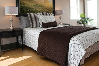 This is an example of a large contemporary bedroom in Other with beige walls and bamboo floors.
