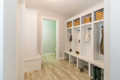 Inspiration for a mid-sized vinyl floor and brown floor hallway remodel in Other with gray walls