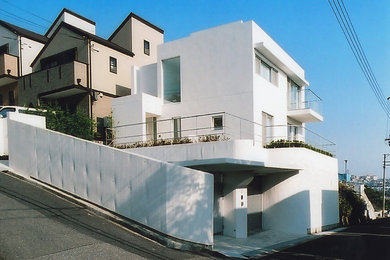 Modern two-storey concrete white house exterior in Kobe.