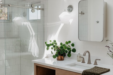 Example of a small 1960s master white tile and porcelain tile terrazzo floor, multicolored floor, single-sink and vaulted ceiling bathroom design in Detroit with flat-panel cabinets, light wood cabinets, white walls, an undermount sink, quartz countertops, white countertops and a built-in vanity