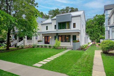 Example of a mid-sized minimalist white two-story stucco exterior home design in Chicago with a metal roof and a gray roof