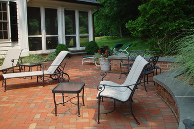 Photo of a mid-sized traditional backyard patio in New York with brick pavers and no cover.