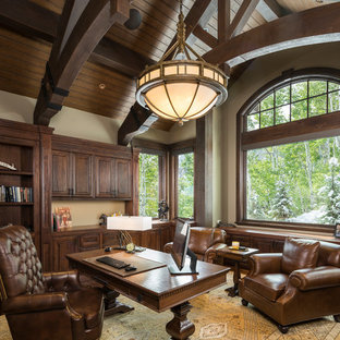 Photo of a medium sized rustic study in Salt Lake City with beige walls, dark hardwood flooring, no fireplace, a freestanding desk and brown floors.